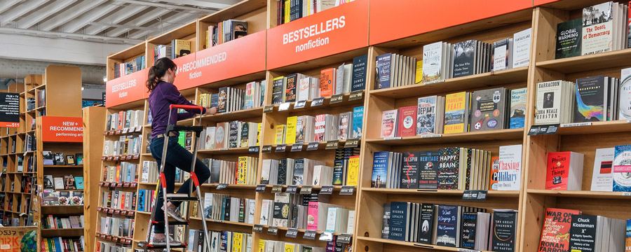 Powell's Books employee stocking shelves